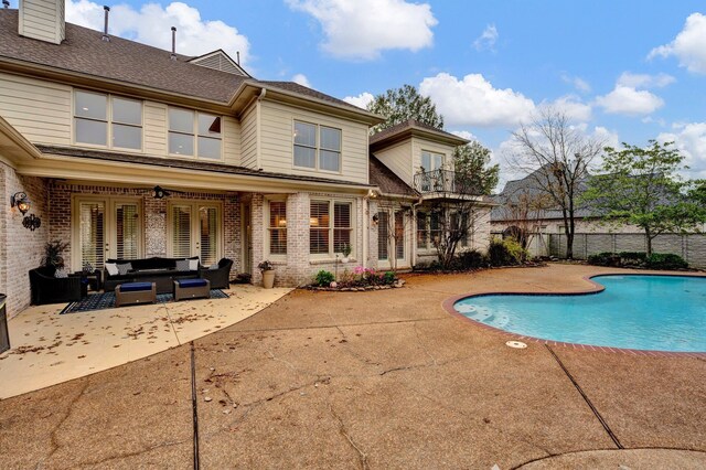 view of pool with outdoor lounge area and a patio