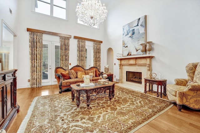 living room with hardwood / wood-style floors, plenty of natural light, and a premium fireplace