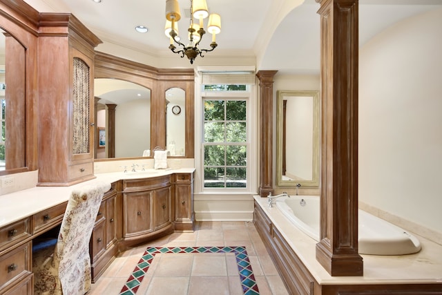 bathroom featuring a notable chandelier, decorative columns, tiled tub, vanity, and ornamental molding