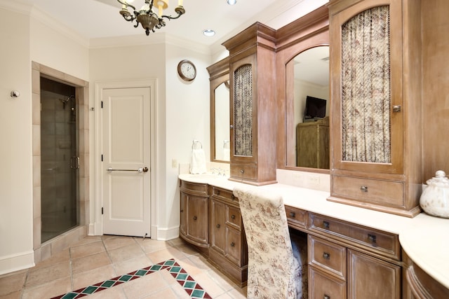 bathroom with tile patterned floors, a chandelier, a shower with door, vanity, and ornamental molding