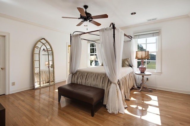 bedroom with ceiling fan, light hardwood / wood-style flooring, and crown molding