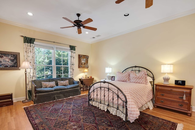 bedroom with ceiling fan, ornamental molding, and light hardwood / wood-style flooring