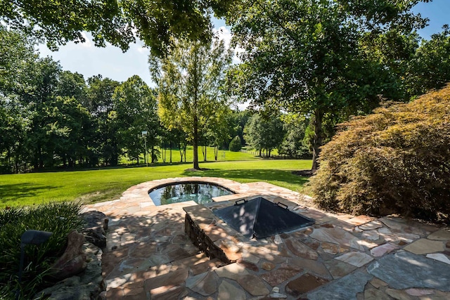 view of swimming pool featuring a yard, a patio, and a hot tub