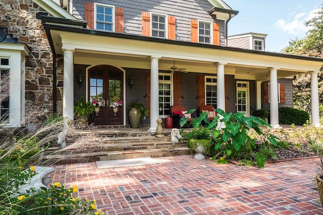 entrance to property featuring ceiling fan, covered porch, and french doors