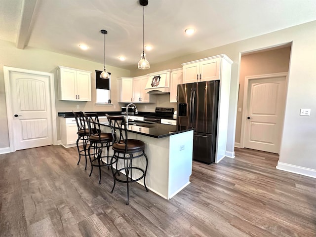 kitchen featuring white cabinets, dark hardwood / wood-style flooring, stainless steel appliances, and an island with sink