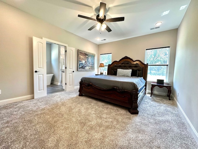 bedroom with ceiling fan, carpet floors, and connected bathroom