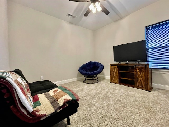 living area featuring carpet flooring and ceiling fan