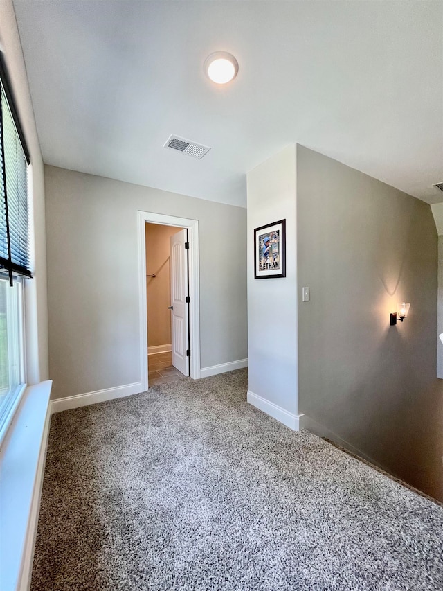 carpeted empty room featuring a wealth of natural light