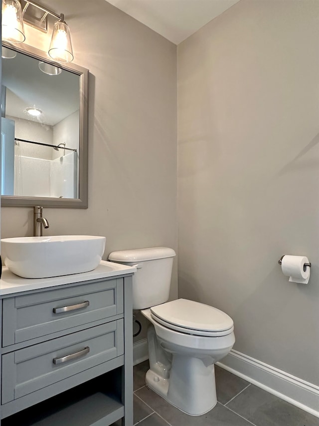 bathroom featuring tile patterned flooring, a shower with curtain, vanity, and toilet