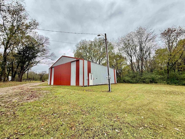 view of outbuilding featuring a lawn