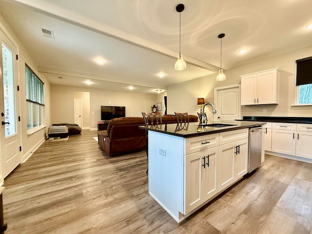 kitchen featuring white cabinetry, sink, dishwasher, and hanging light fixtures