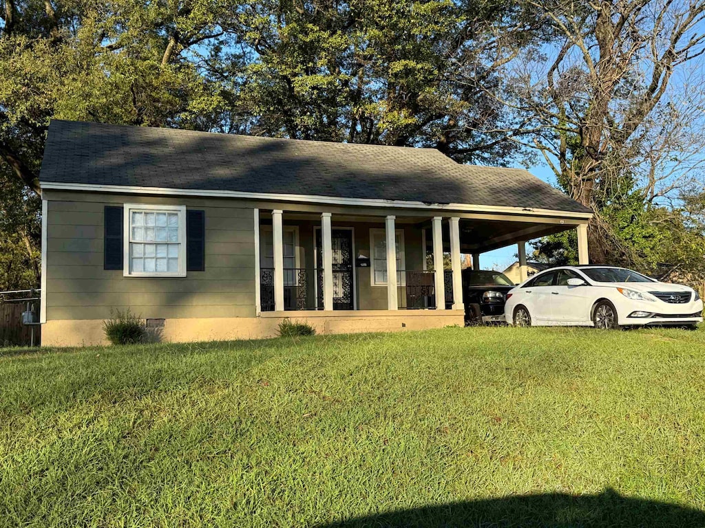 view of front of house with covered porch, a front yard, and a carport