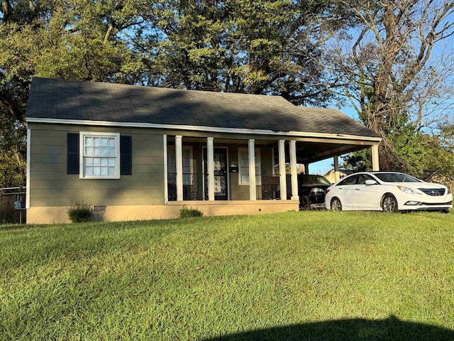 view of front of house with covered porch, a front yard, and a carport