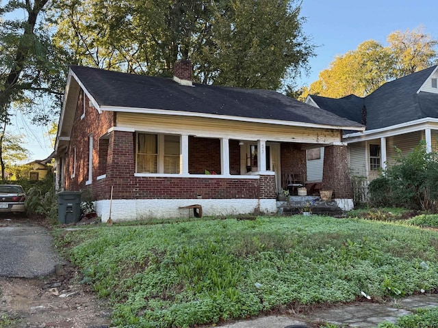573 Stephens Pl, Memphis, TN 38126 - view of front of house with brick siding, a chimney, and covered porch