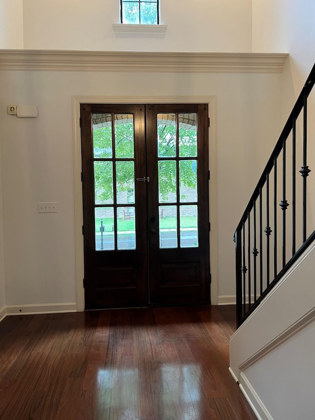 entryway with plenty of natural light, dark hardwood / wood-style floors, and french doors