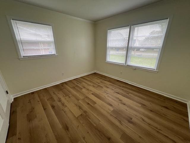 empty room featuring hardwood / wood-style flooring and a healthy amount of sunlight