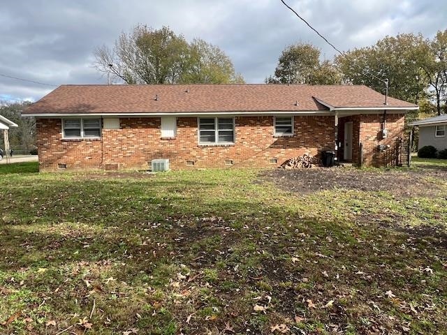 back of house with a yard and cooling unit