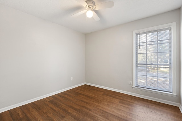 empty room with hardwood / wood-style flooring and ceiling fan