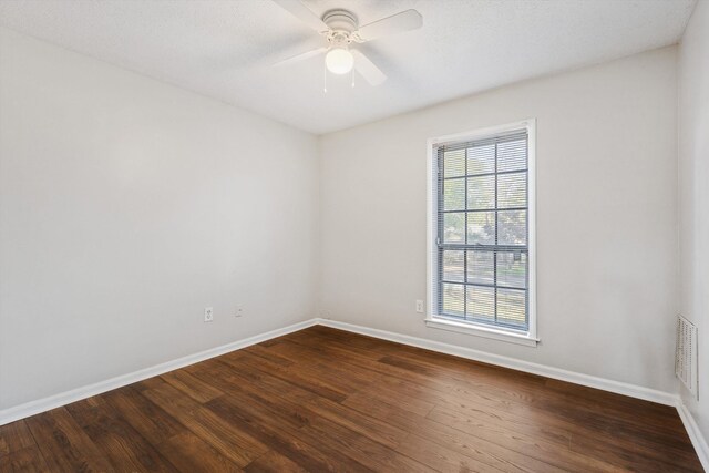 spare room featuring ceiling fan and dark hardwood / wood-style flooring