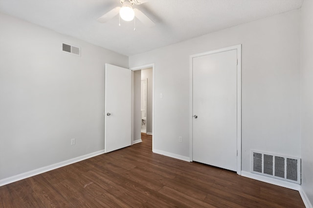 unfurnished bedroom with dark hardwood / wood-style flooring and ceiling fan