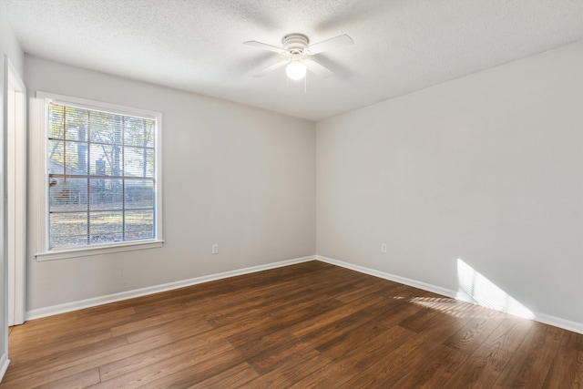 spare room featuring a textured ceiling, ceiling fan, and dark wood-type flooring