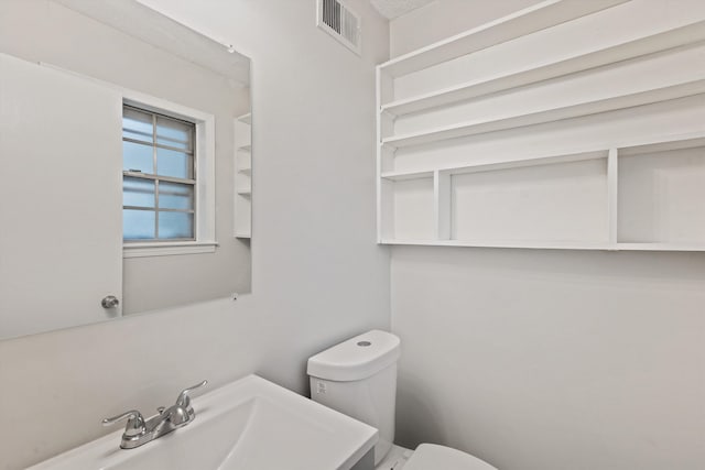 bathroom with toilet and sink