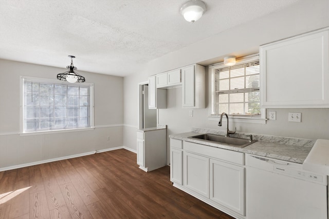 kitchen with dishwasher, sink, dark wood-type flooring, decorative light fixtures, and white cabinets