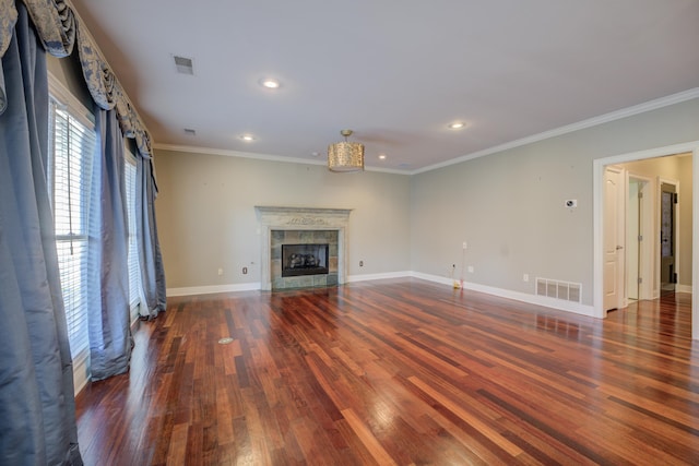 unfurnished living room featuring a fireplace, ornamental molding, and dark wood-type flooring