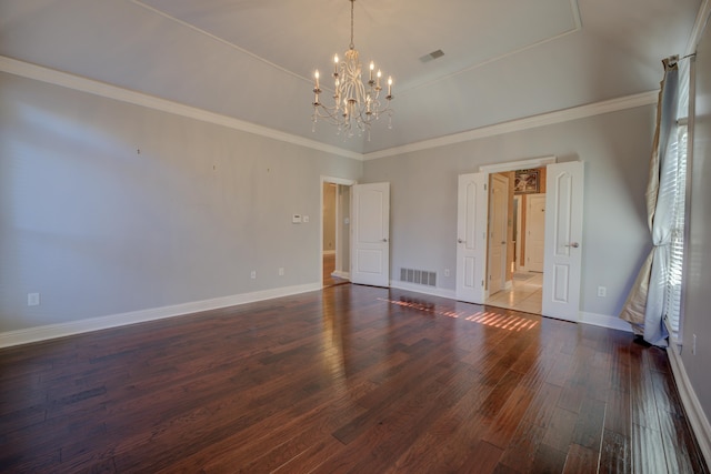 unfurnished room with dark hardwood / wood-style floors, crown molding, and a chandelier