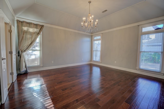 empty room with a chandelier, dark wood-type flooring, and ornamental molding