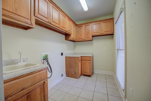 washroom with cabinets, washer hookup, a wealth of natural light, and sink