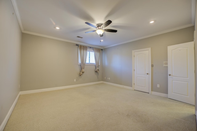 spare room with light carpet, ceiling fan, and ornamental molding