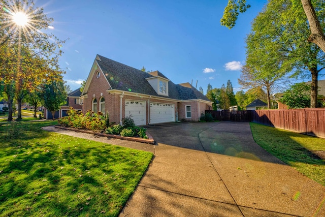 view of side of home featuring a garage and a yard