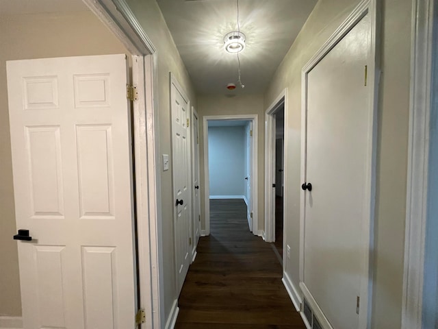 hallway with dark wood-type flooring