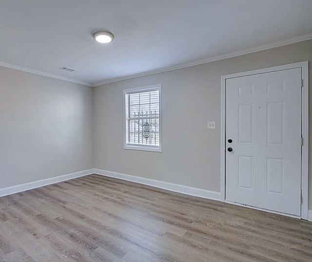 entrance foyer featuring light hardwood / wood-style floors and crown molding