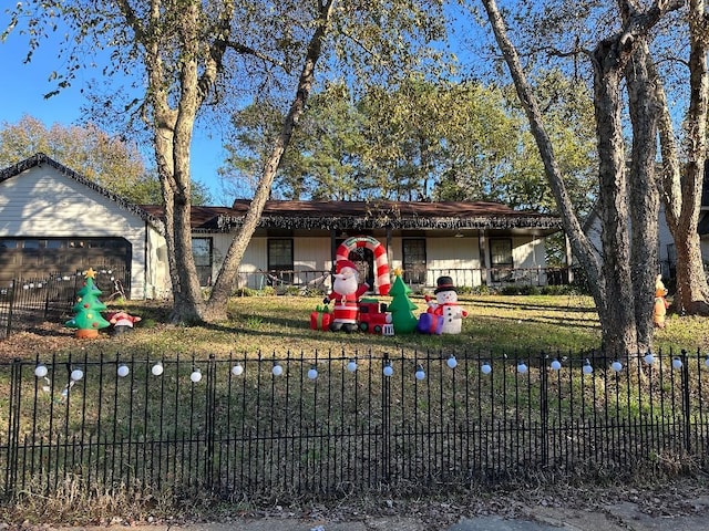 ranch-style house with a garage and a front lawn