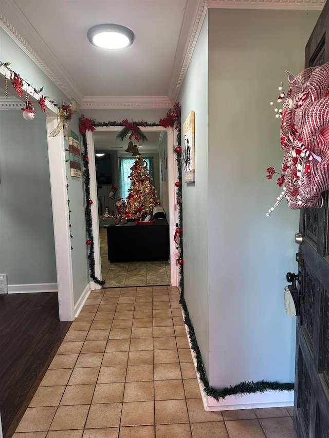 corridor featuring tile patterned flooring and ornamental molding