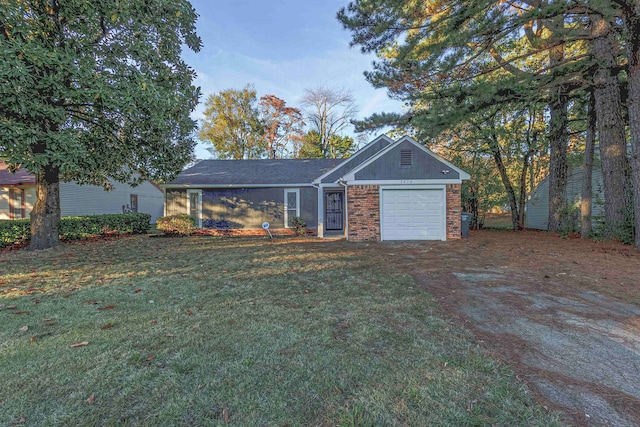 single story home featuring a garage and a front yard