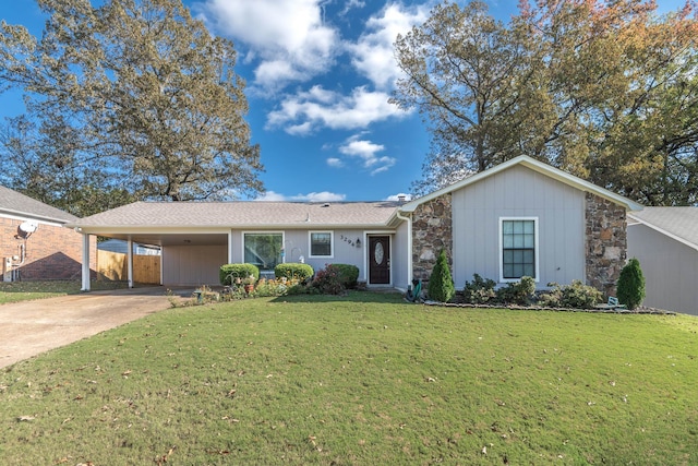 single story home featuring a front lawn and a carport