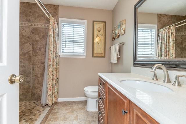 bathroom featuring a shower with shower curtain, vanity, a healthy amount of sunlight, and toilet