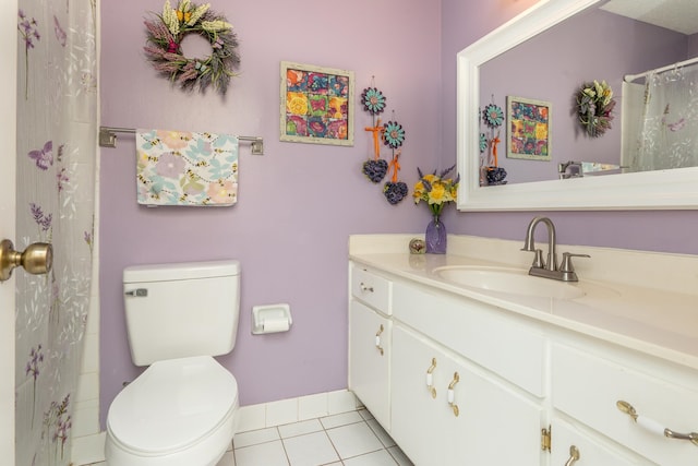 bathroom with tile patterned floors, vanity, and toilet