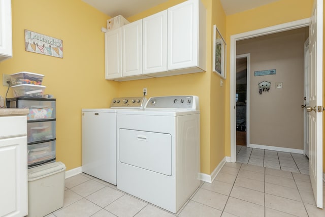 washroom with light tile patterned floors, cabinets, and independent washer and dryer