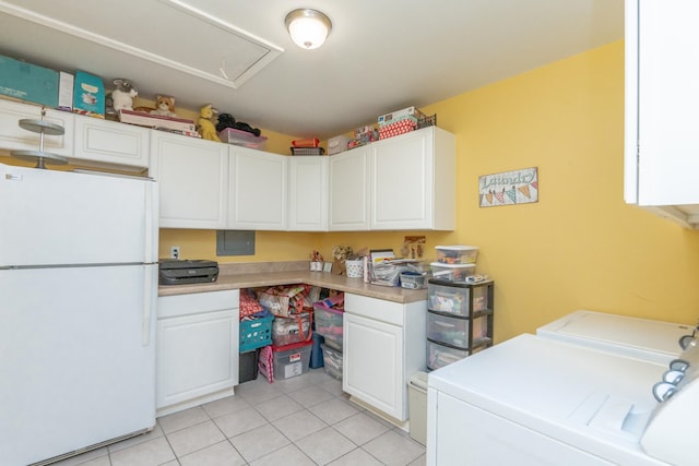 interior space featuring cabinets, separate washer and dryer, and light tile patterned floors