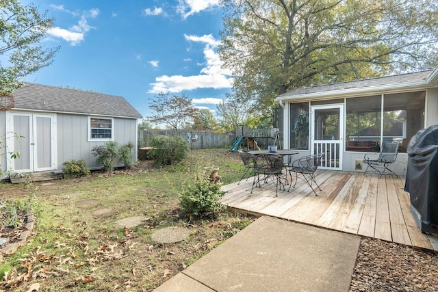 view of yard featuring a sunroom and a deck