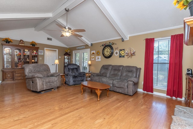 living room with lofted ceiling with beams, light hardwood / wood-style floors, ceiling fan, and ornamental molding