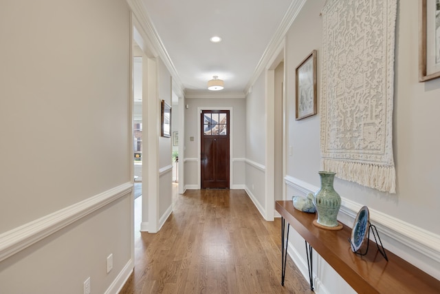 doorway with wood-type flooring and ornamental molding