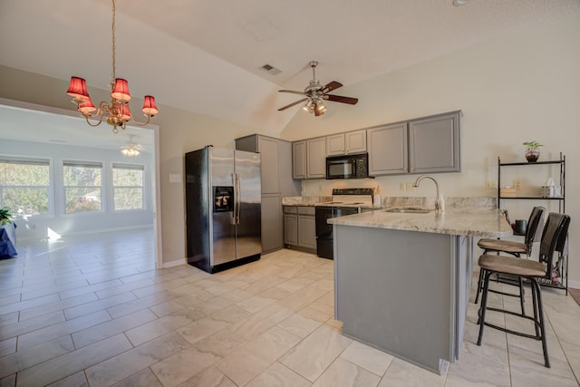 kitchen featuring gray cabinetry, sink, kitchen peninsula, lofted ceiling, and black appliances