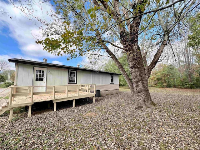 back of property featuring cooling unit and a deck