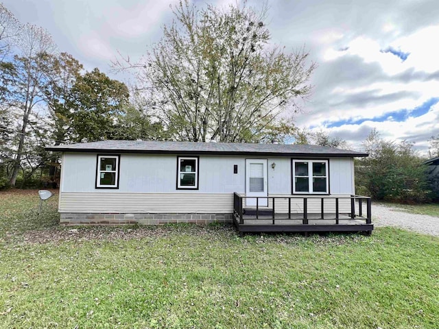 view of front of property with a front lawn and a deck