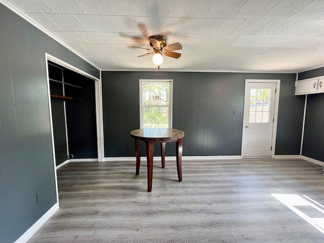 unfurnished dining area featuring hardwood / wood-style flooring, ceiling fan, and a healthy amount of sunlight